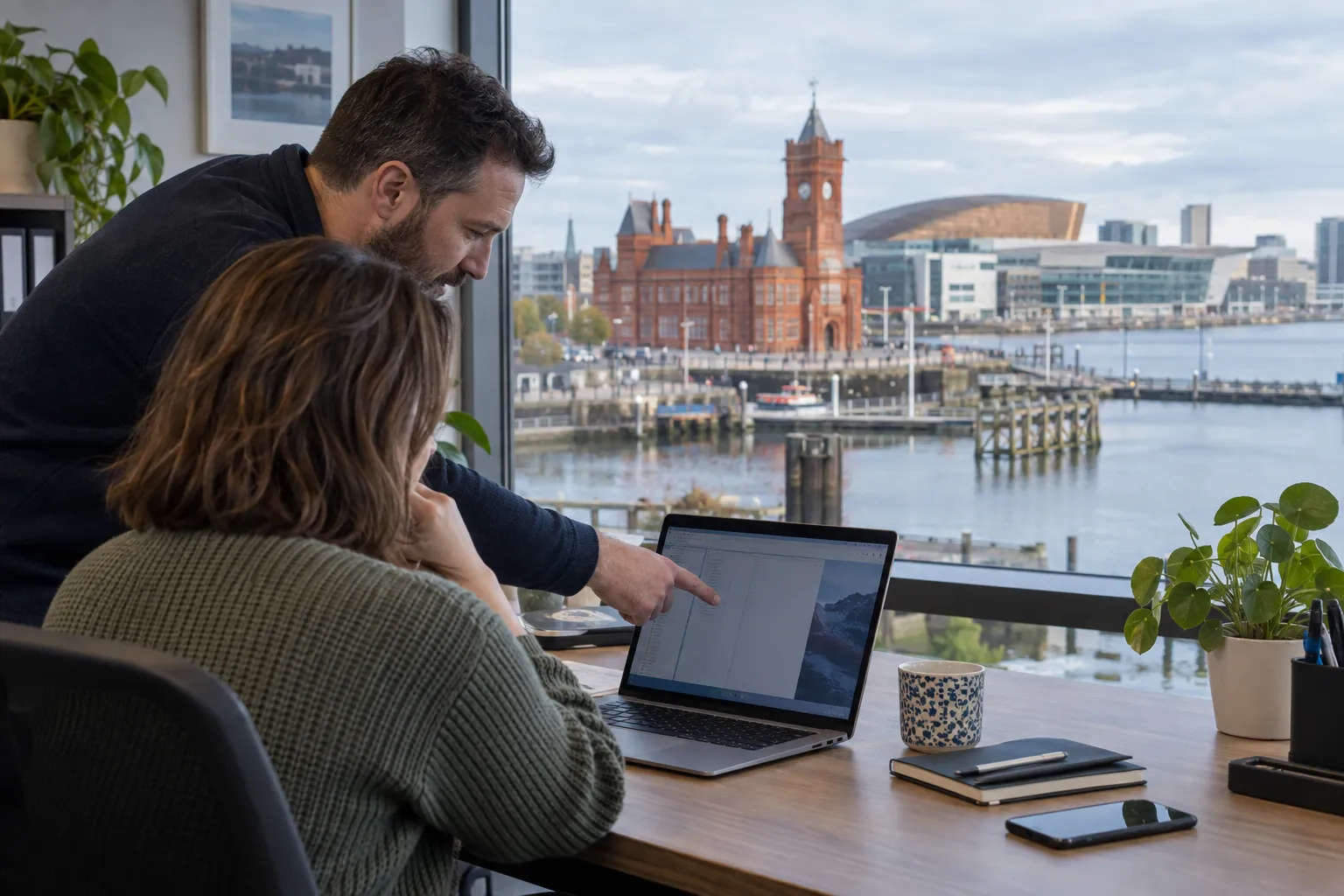 Illustrative laptop support visit overlooking Cardiff Bay